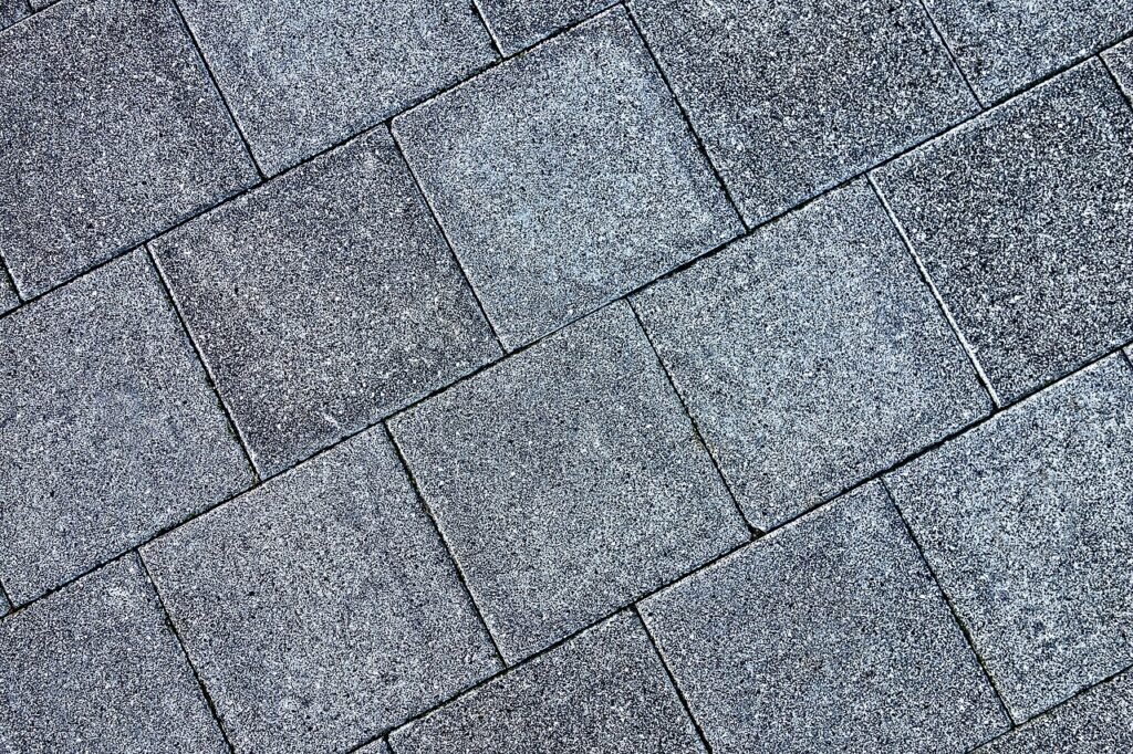 Grijze betontegels in halfsteens verband als terrasbestrating